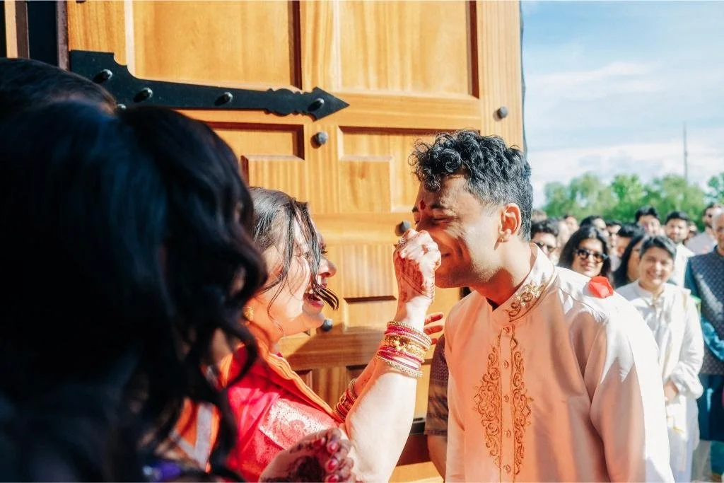 Playful moment between wedding guests as they arrive for the celebration