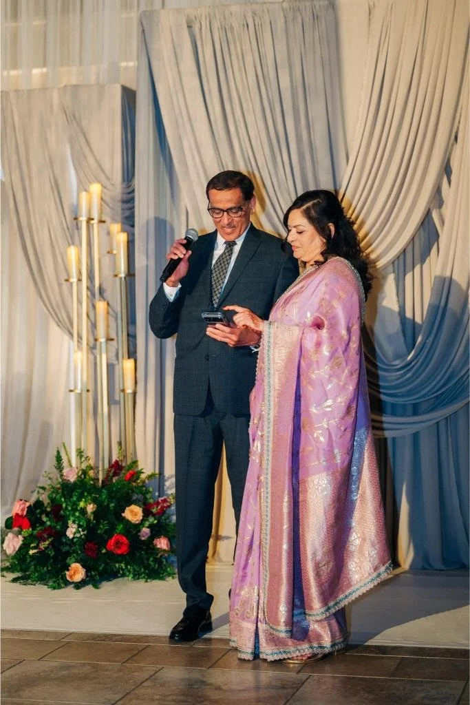 Parents giving a speech during Nishi and Rohan’s wedding reception