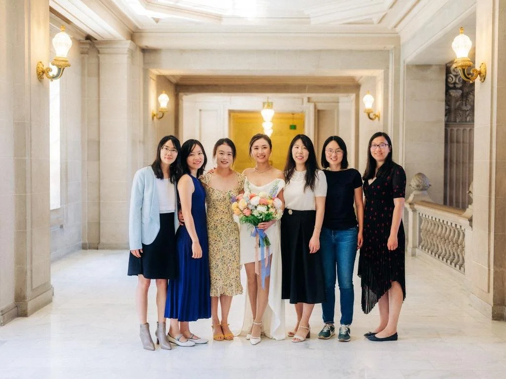 Bride posing with friends after her San Francisco City Hall wedding ceremony.