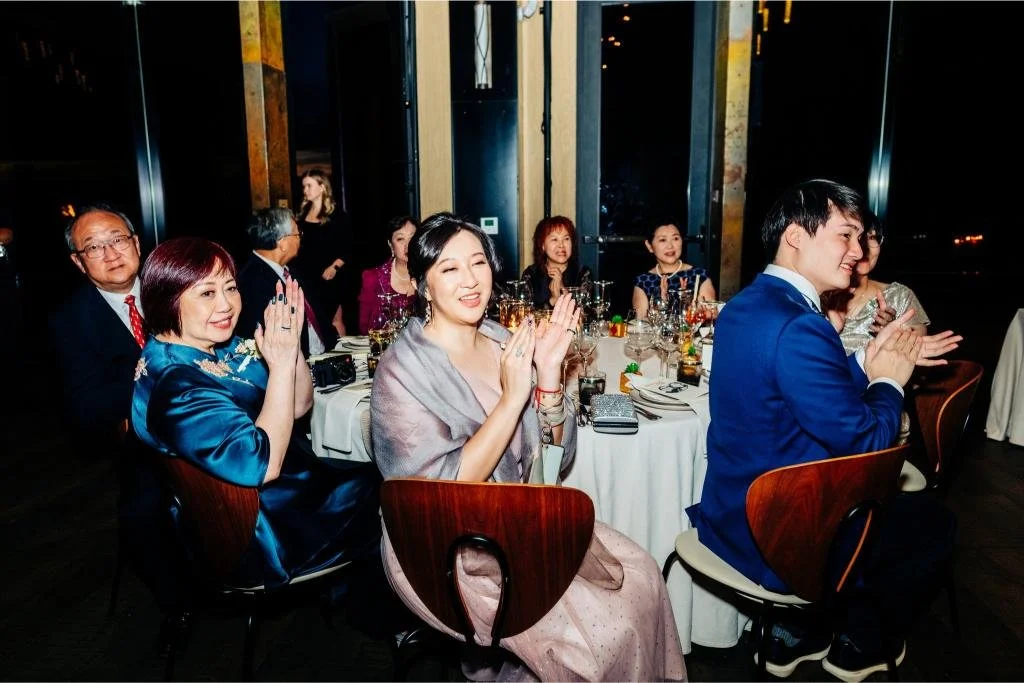 Wedding guests clapping during the reception