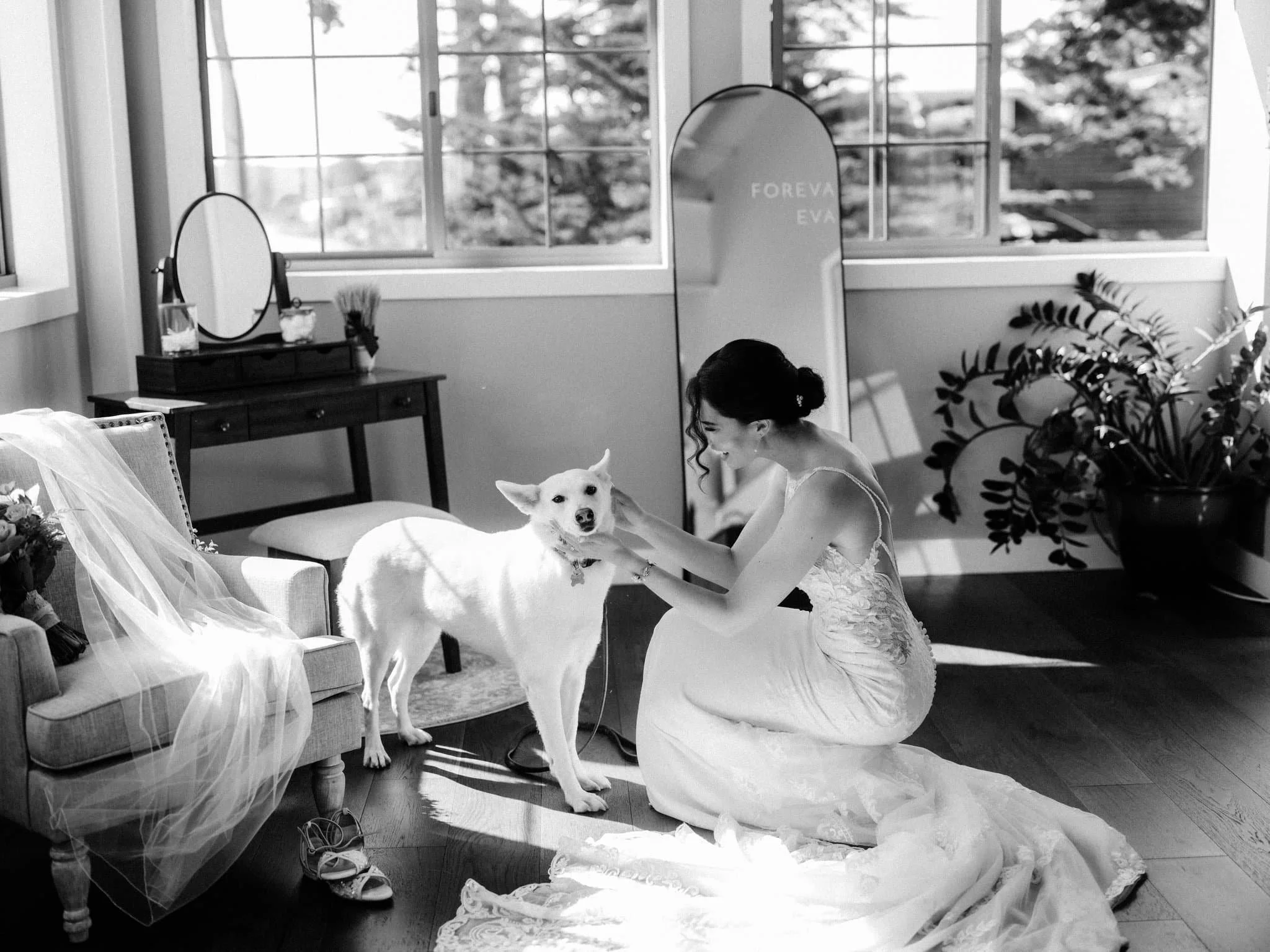 Bride petting her dog Layla while getting ready for wedding at Maverick’s Beach House in Half Moon Bay