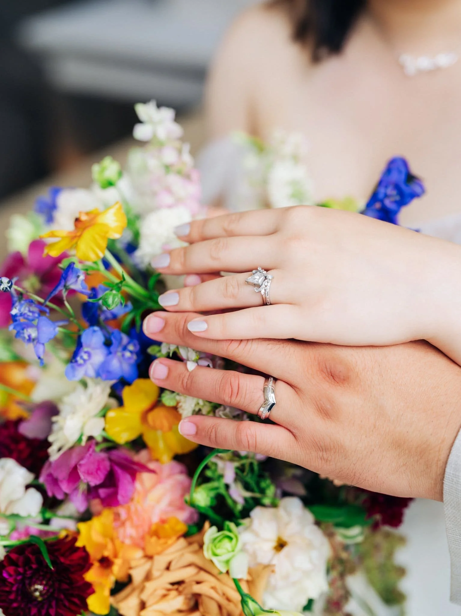 Close-up of the couple’s wedding rings with the bride’s bouquet during their San Francisco City Hall elopement.