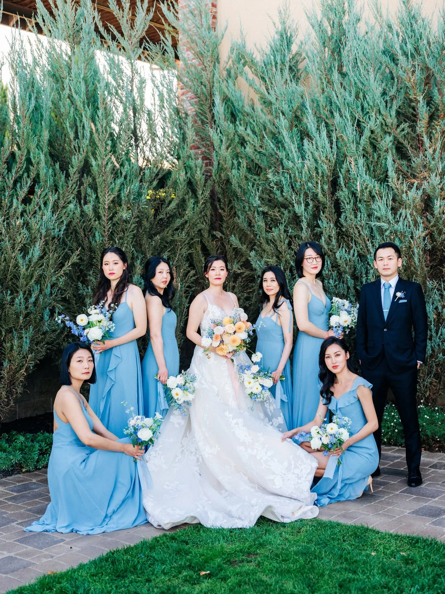 bride posing with bridesmaids group photo palm event center pleasanton wedding
