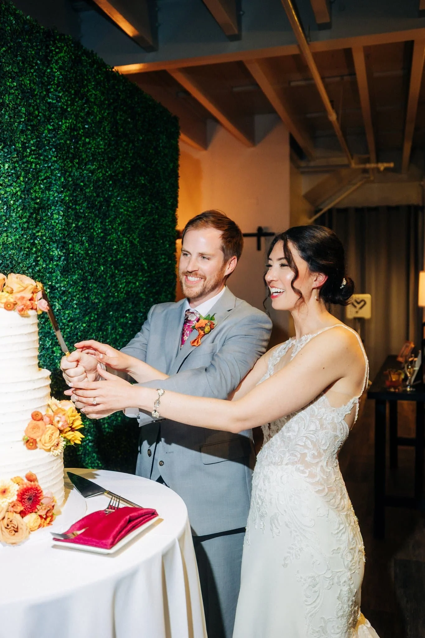 Bride and groom cutting wedding cake at Maverick’s Beach House reception in Half Moon Bay