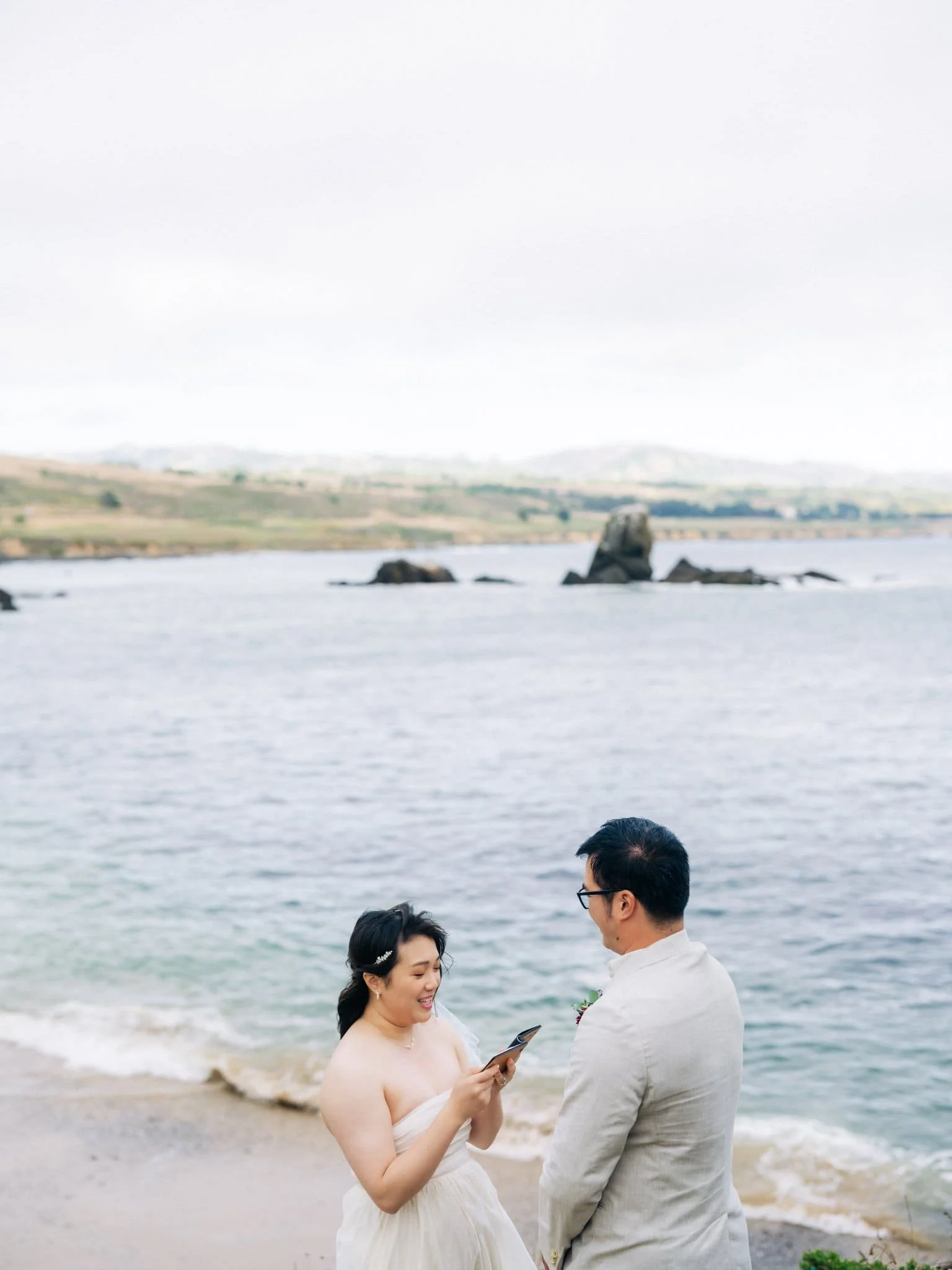 Bride reading her private vows to the groom on the coast during their Pigeon Point Lighthouse elopement.
