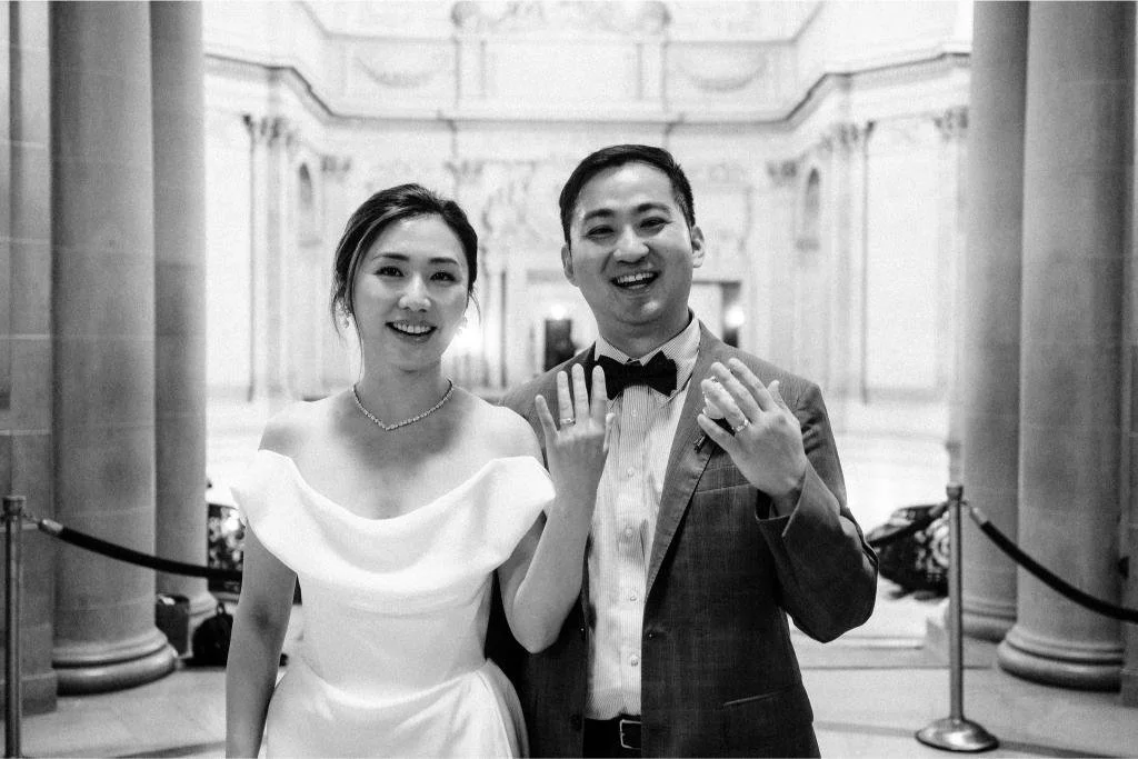 Newlyweds showing their wedding rings to the camera after their San Francisco City Hall ceremony.