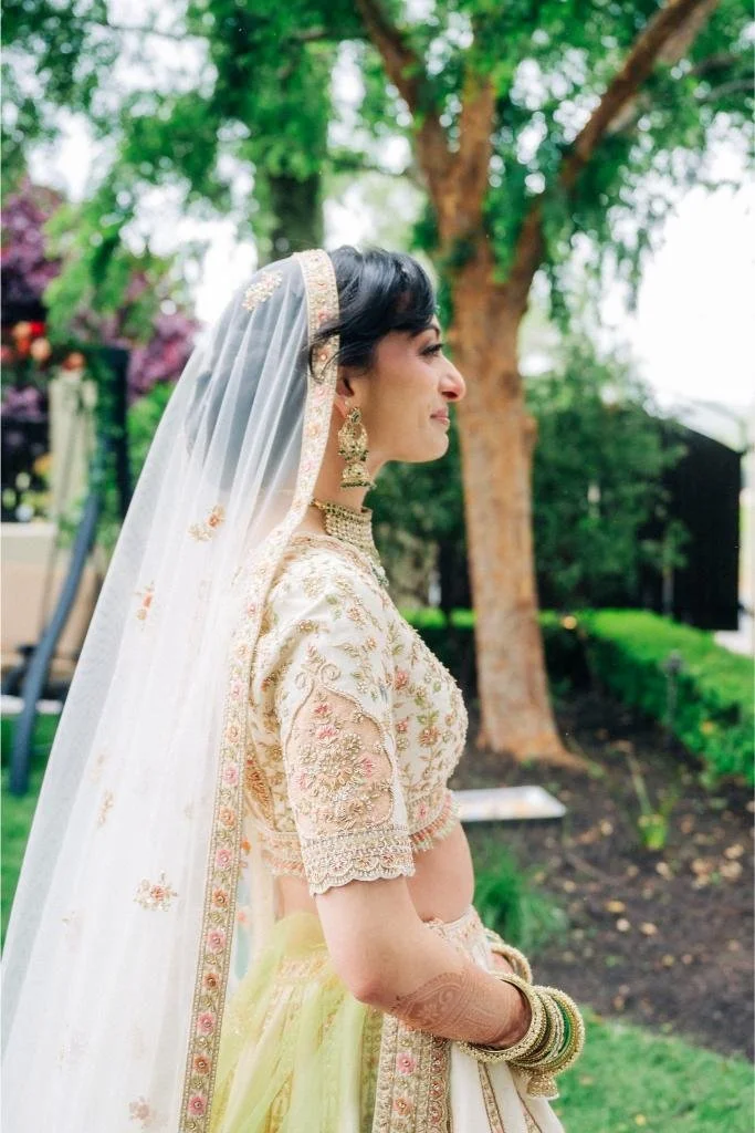 Bride smiling emotionally as she walks down the aisle during the wedding ceremony