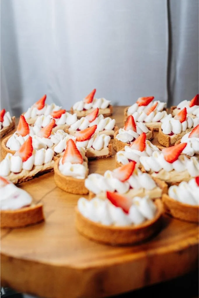 Wedding dessert topped with frosting and a strawberry