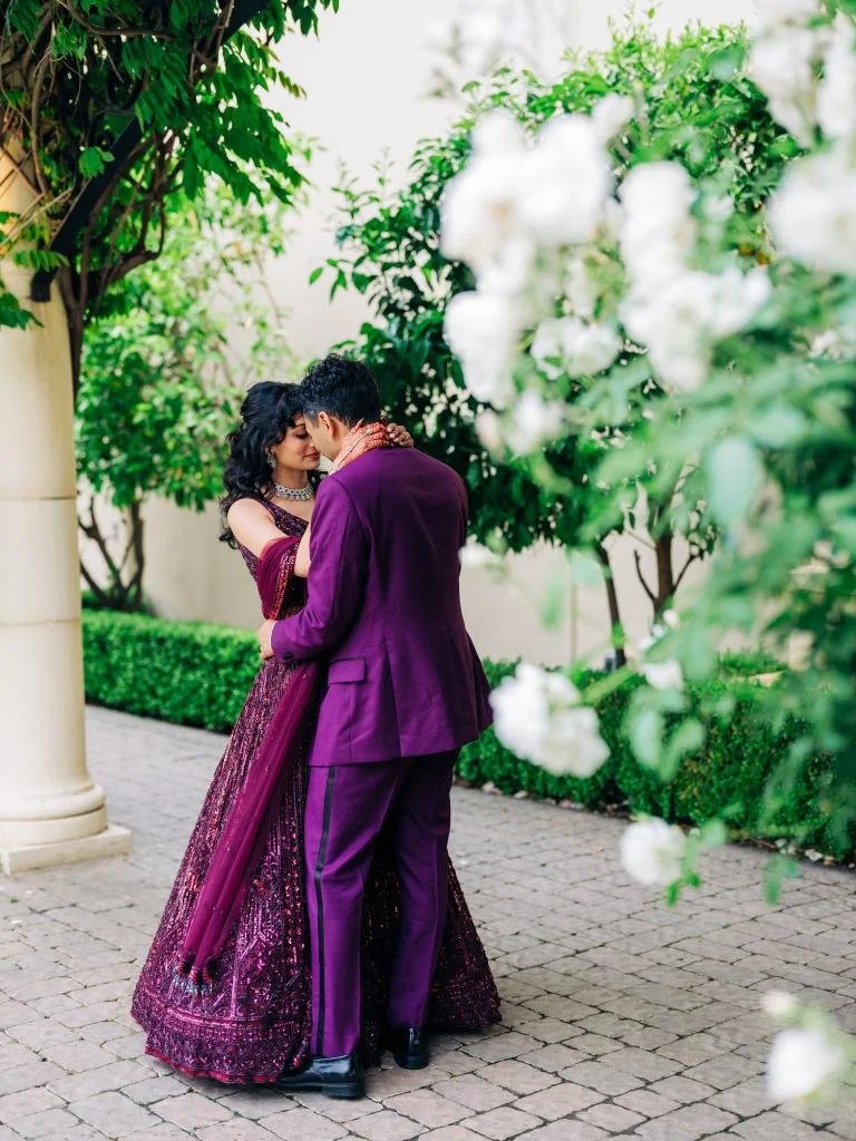 Bride and groom embracing with their foreheads together during wedding portraits