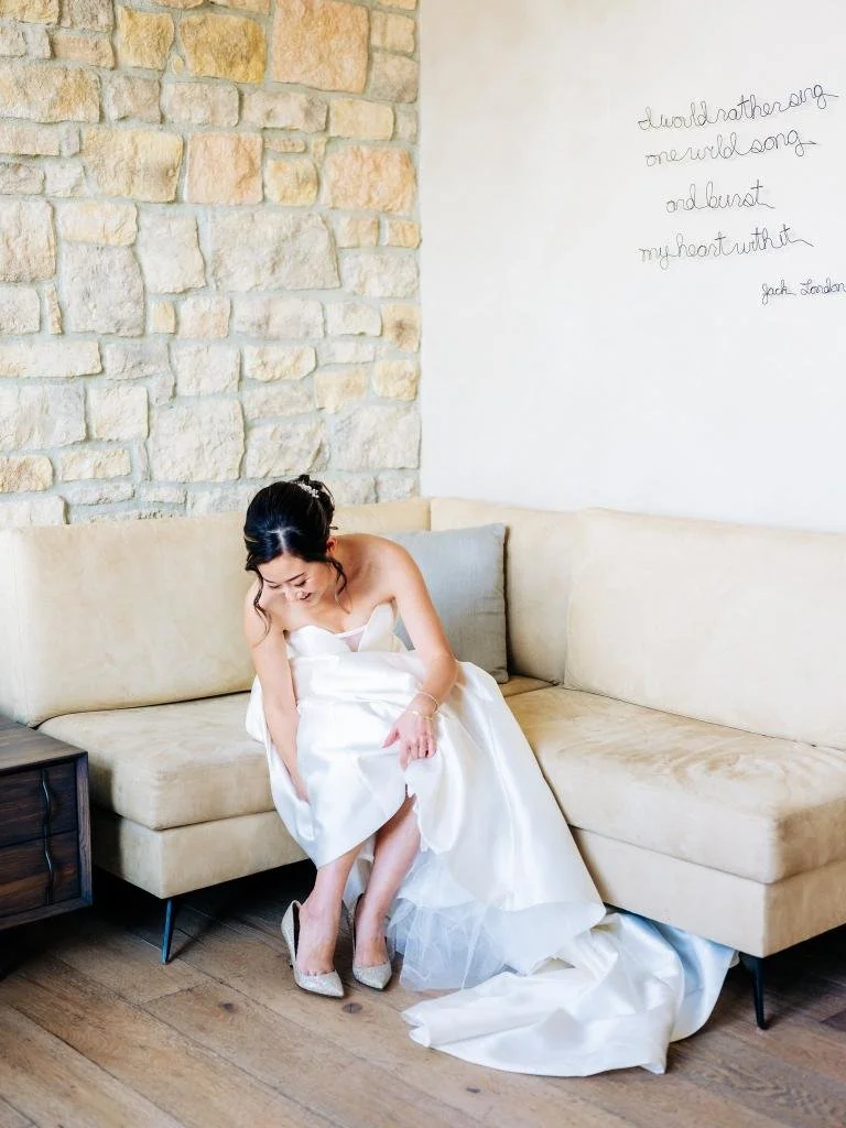 Bride adjusting her shoe while getting ready for her Stanly Ranch wedding