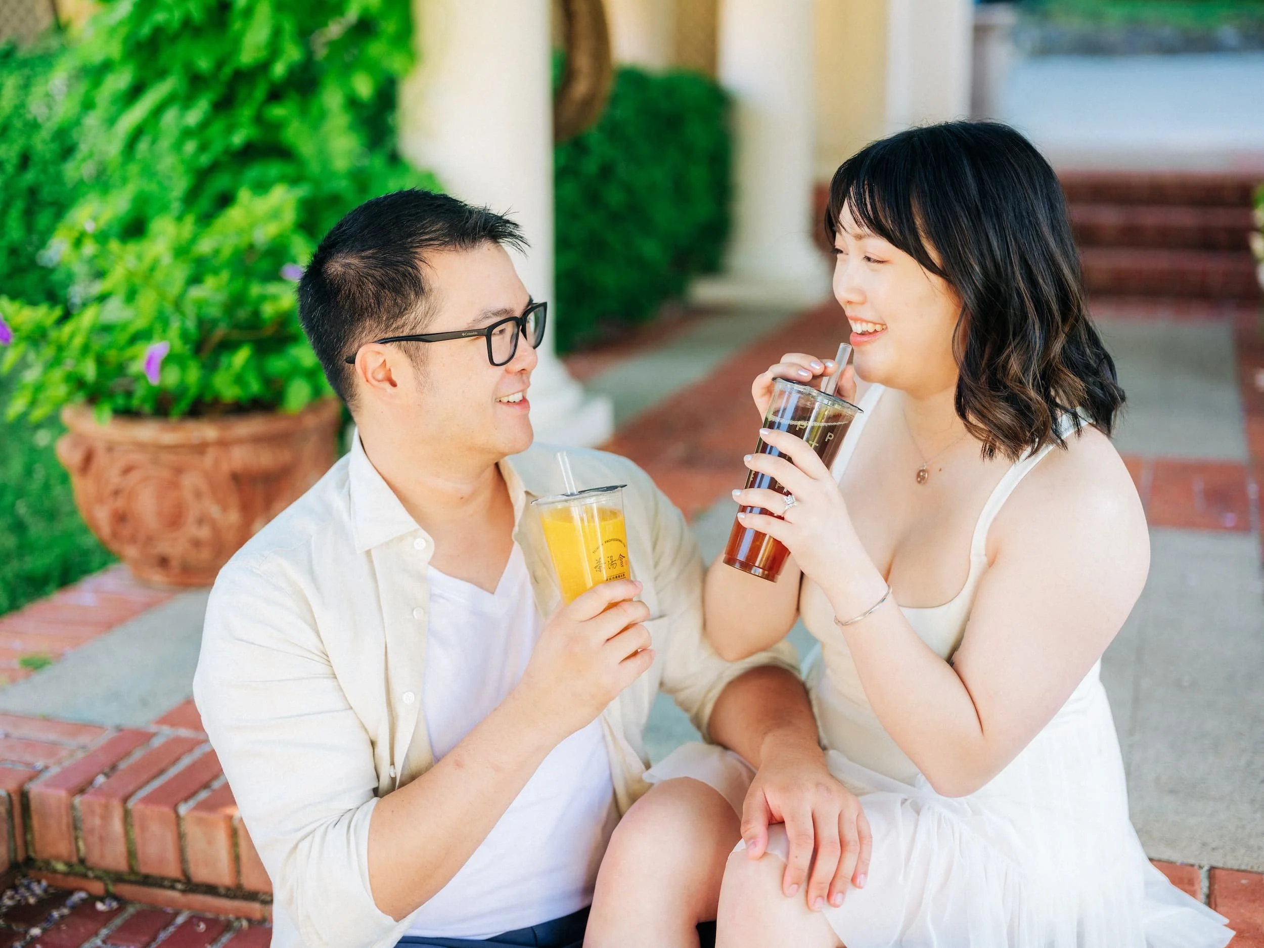 Couple enjoying drinks on the steps of Montalvo Art Center during engagement session