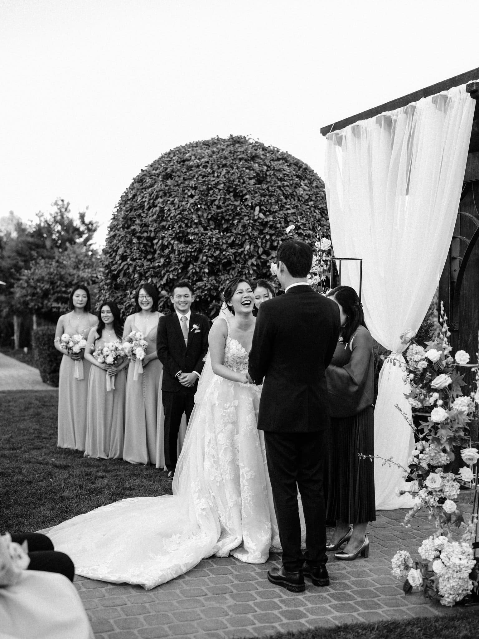 bride and groom laughing at altar during ceremony palm event center pleasanton wedding