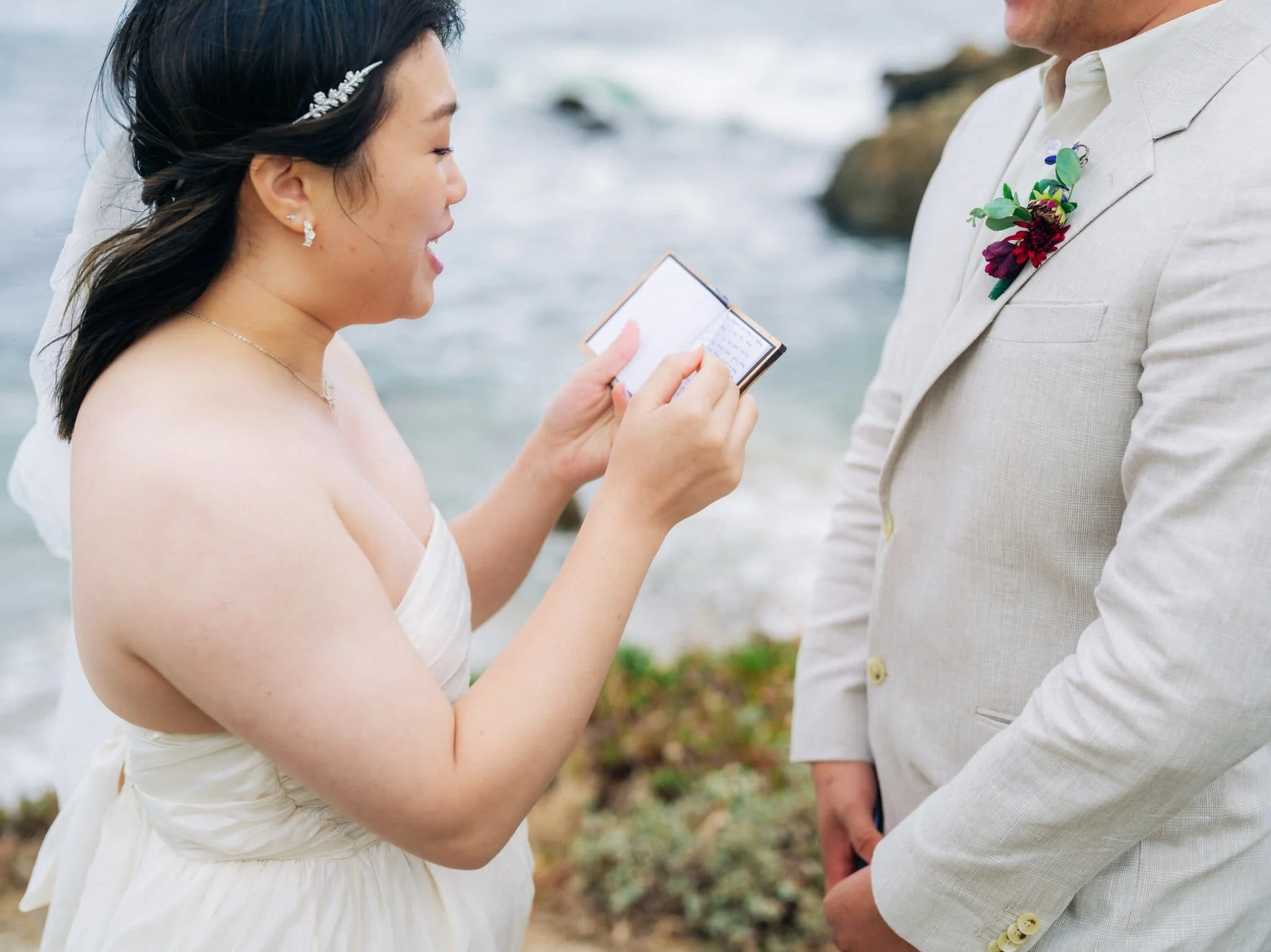 Close-up of the bride reading her private vows during her Pigeon Point Lighthouse elopement.