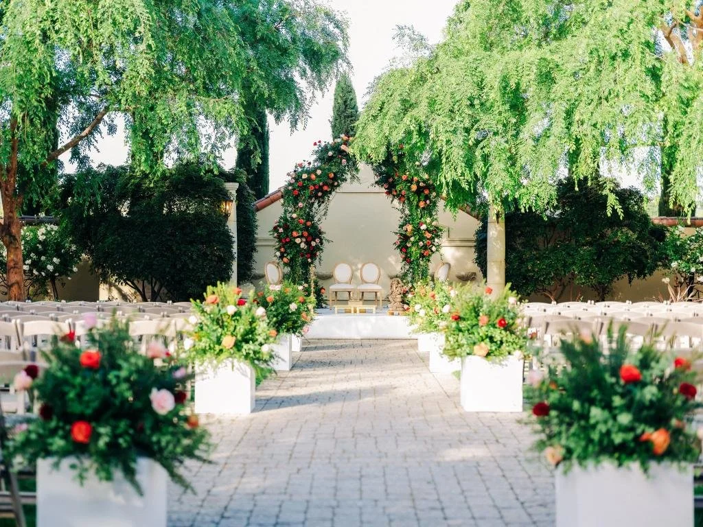 Flower-lined ceremony aisle leading toward the altar before the wedding