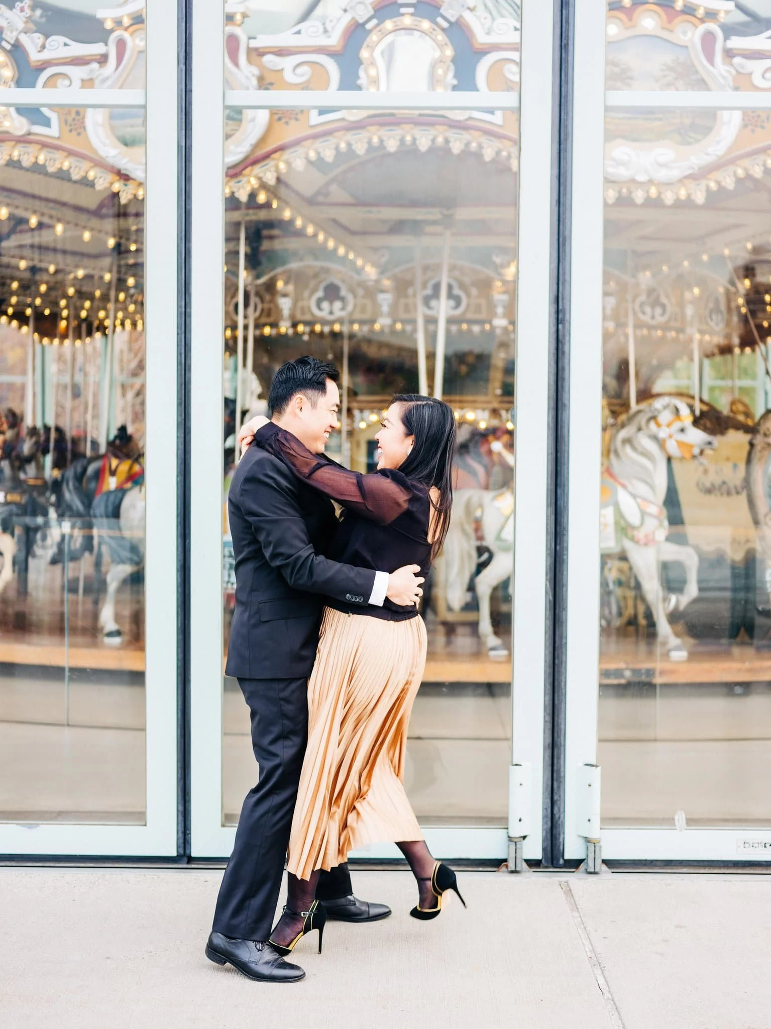 Engaged couple enjoying pizza with the iconic Joe’s Pizza storefront sign behind them during their New York City engagement session.