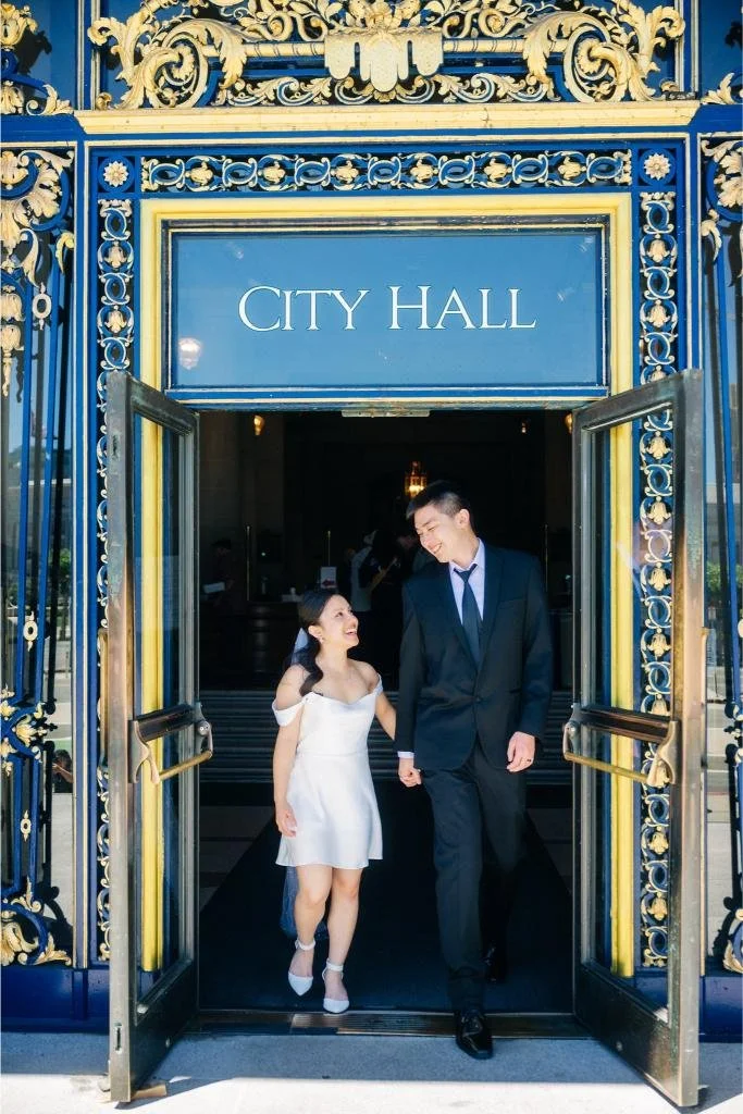 Bride and groom leaving San Francisco City Hall after their elopement