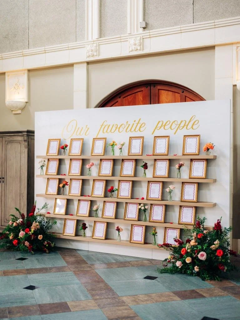 Wall of Our Favorite People featuring framed photos of family and wedding guests