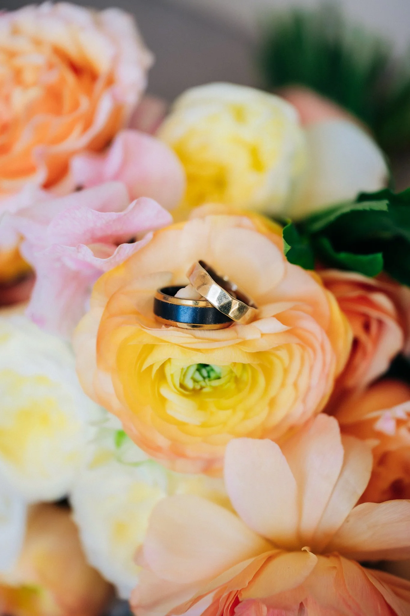 Wedding rings resting on bouquet flowers at San Francisco City Hall wedding