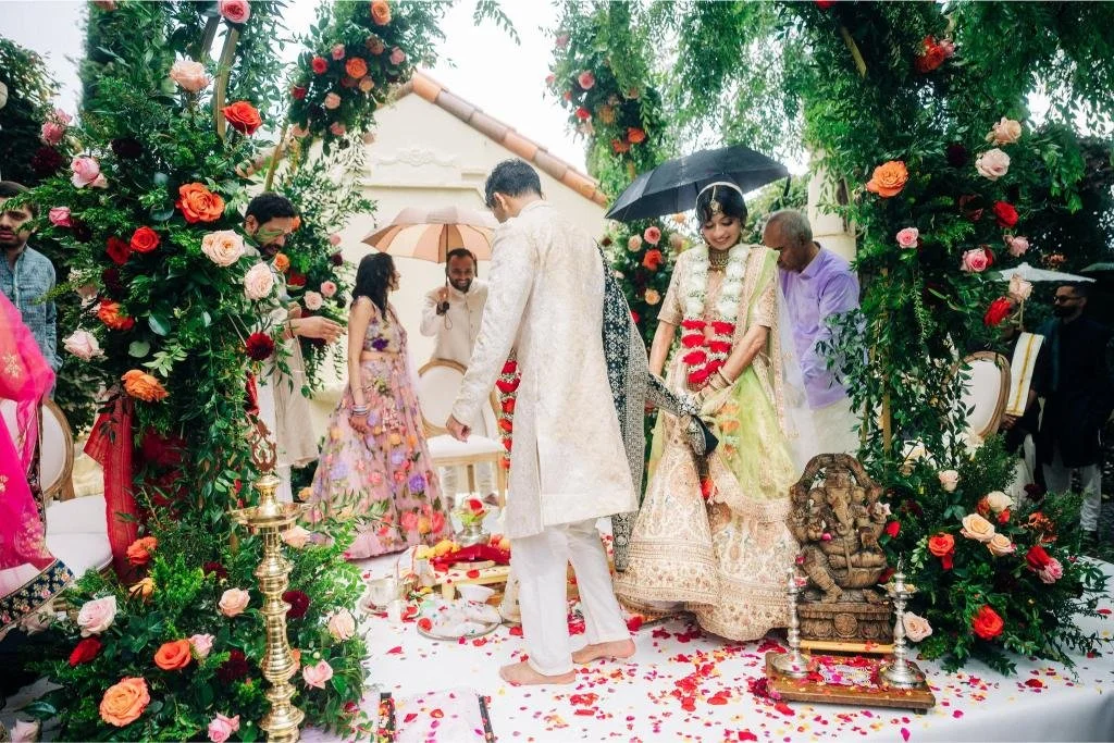 Flower petals scattered at the bride and groom’s feet during the wedding ceremony