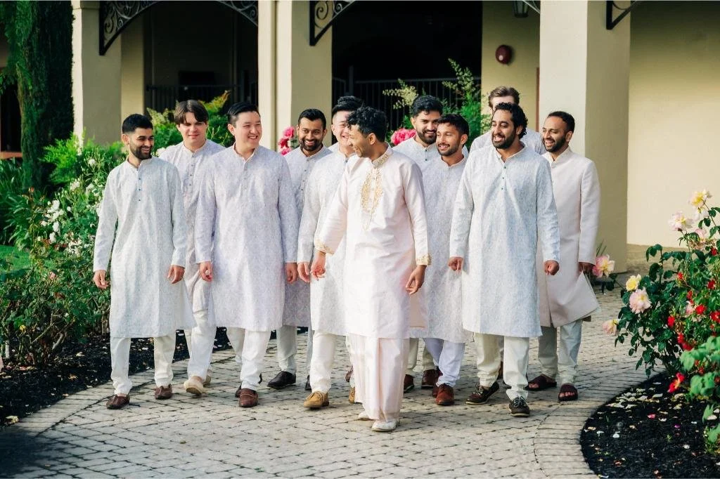 Groom posing with his groomsmen before the wedding ceremony