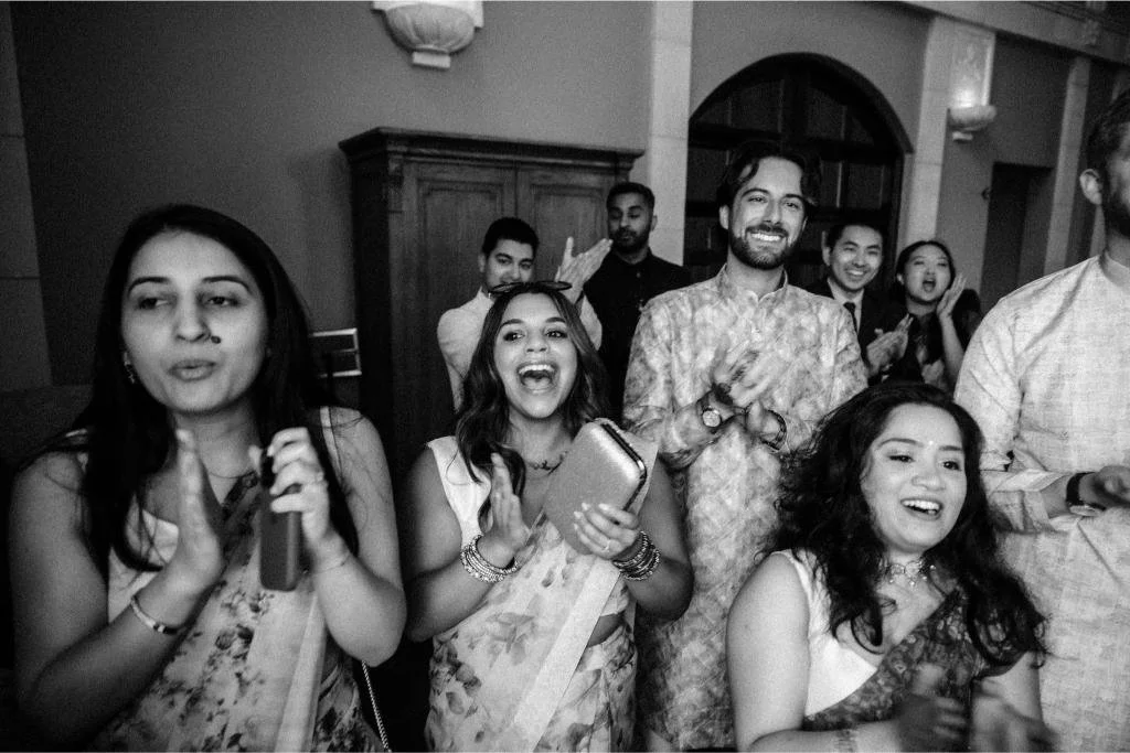 Wedding guests clapping during Nishi and Rohan’s celebration