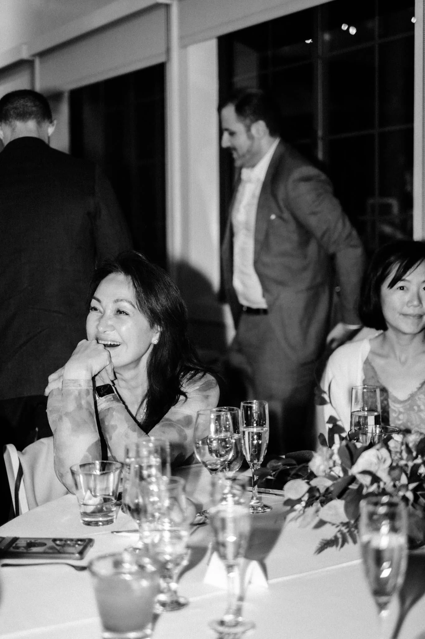 Wedding guest laughing during reception speech at Maverick’s Beach House wedding in Half Moon Bay