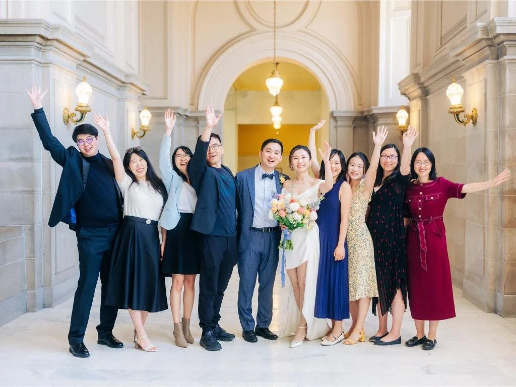 Bride and groom celebrating with their friends after their San Francisco City Hall wedding ceremony.
