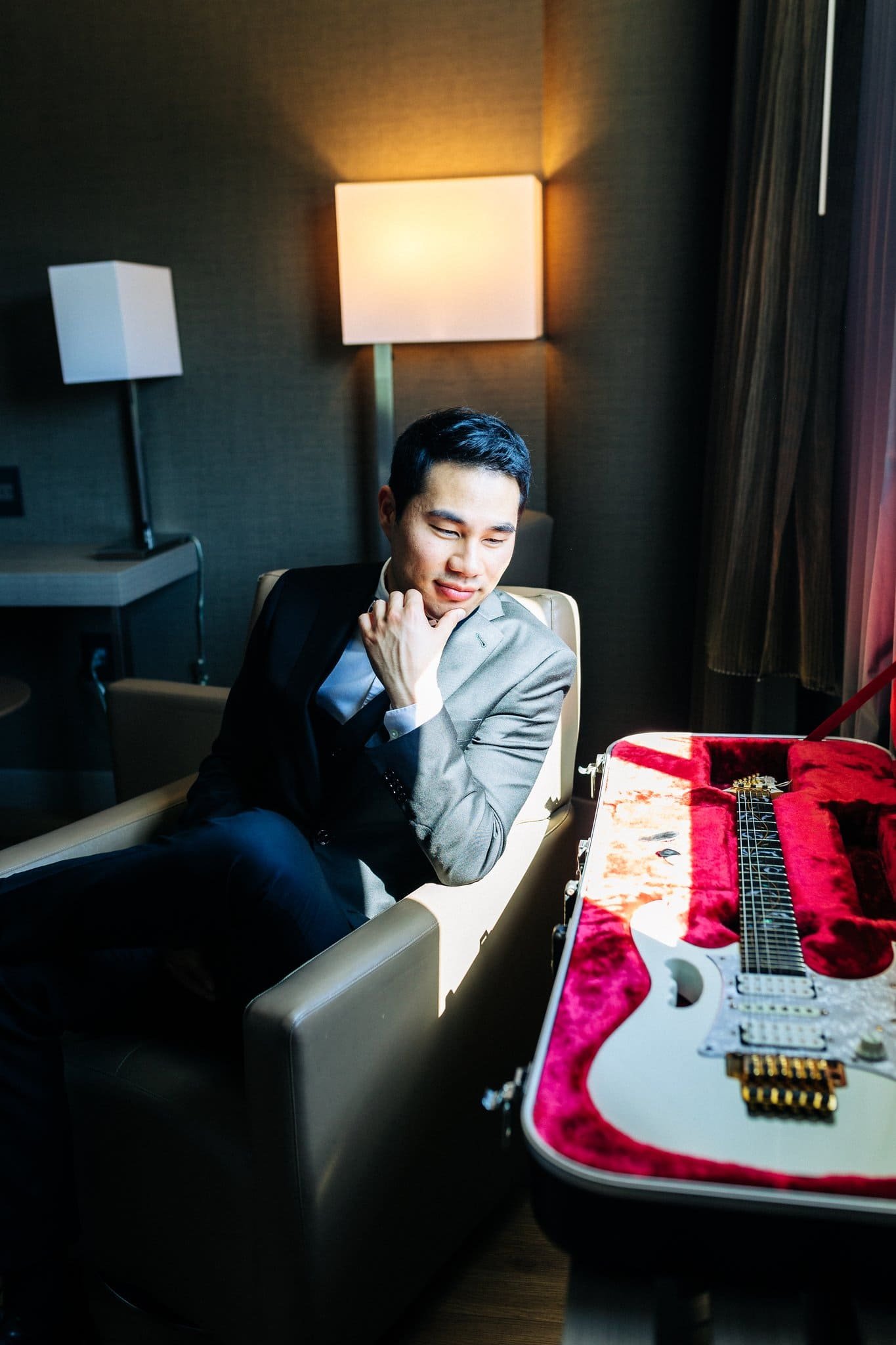 groom dressed in suit with guitar in dressing room palm event center pleasanton wedding