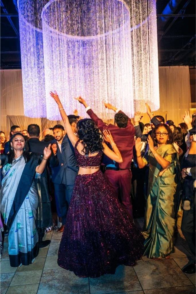 Wedding guests celebrating together on the reception dance floor