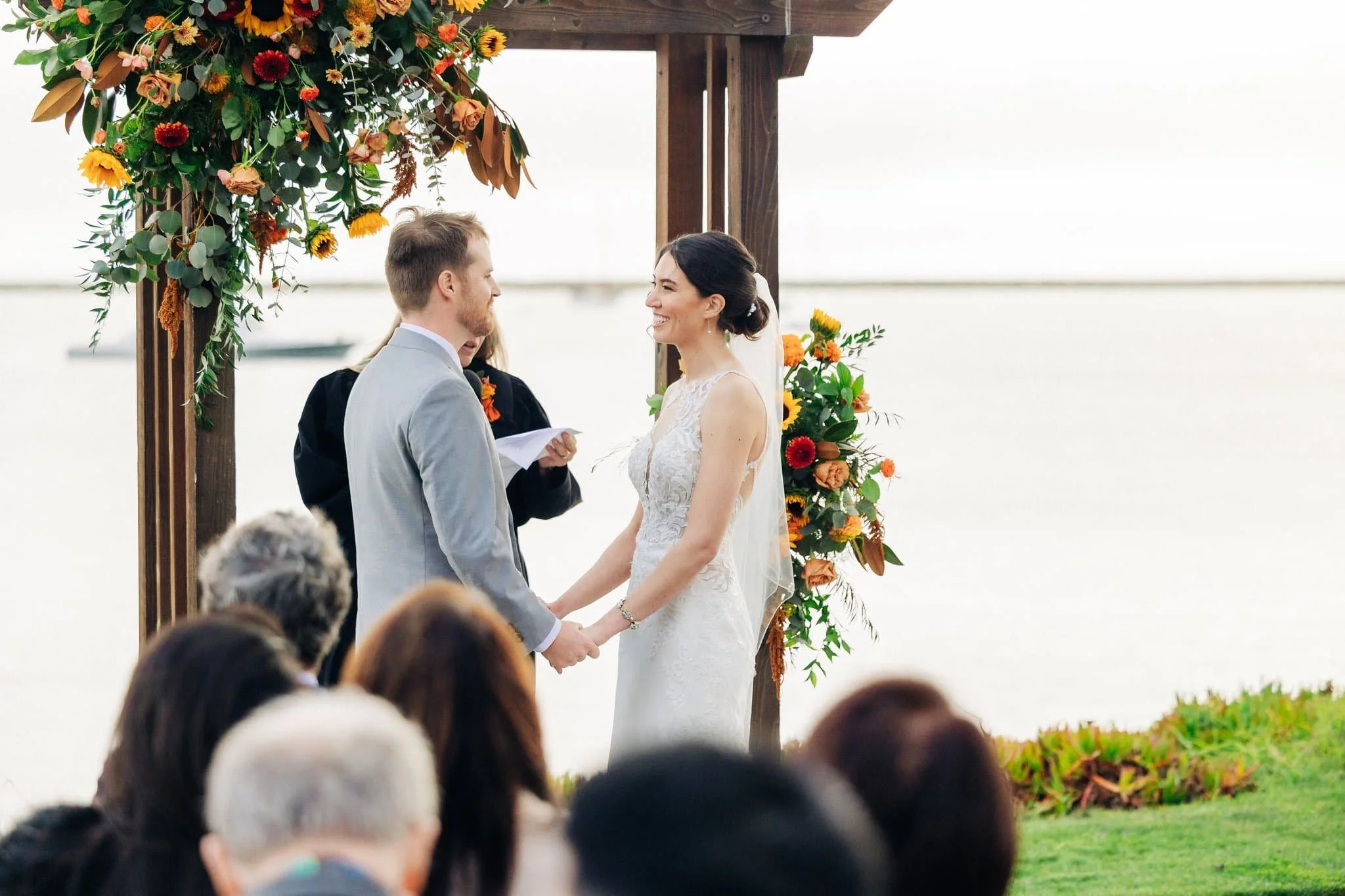 Bride and groom standing at the altar during wedding ceremony at Maverick’s Beach House in Half Moon Bay