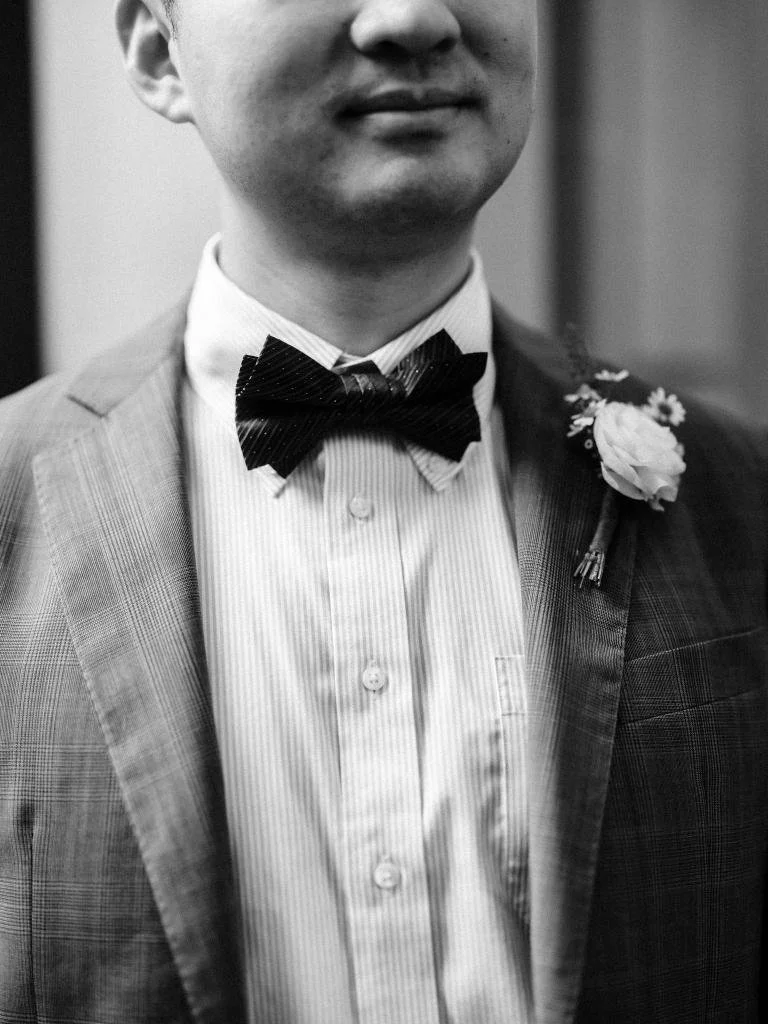 Detail photo of the groom's blue suit and bow tie during his San Francisco City Hall elopement.