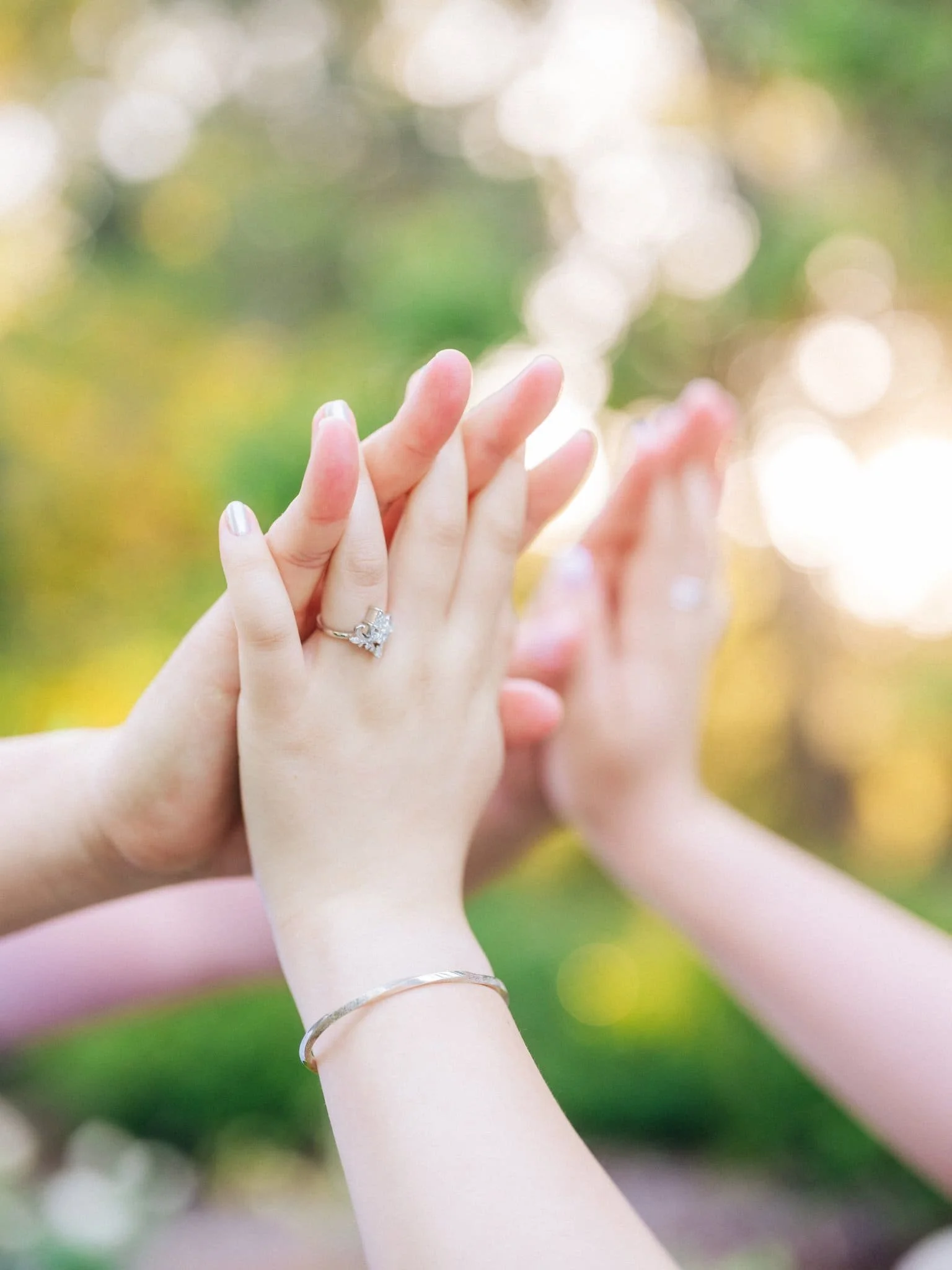 Close-up of the couple standing palm to palm during their Montalvo Arts Center engagement photos in Saratoga, with her engagement ring visible.