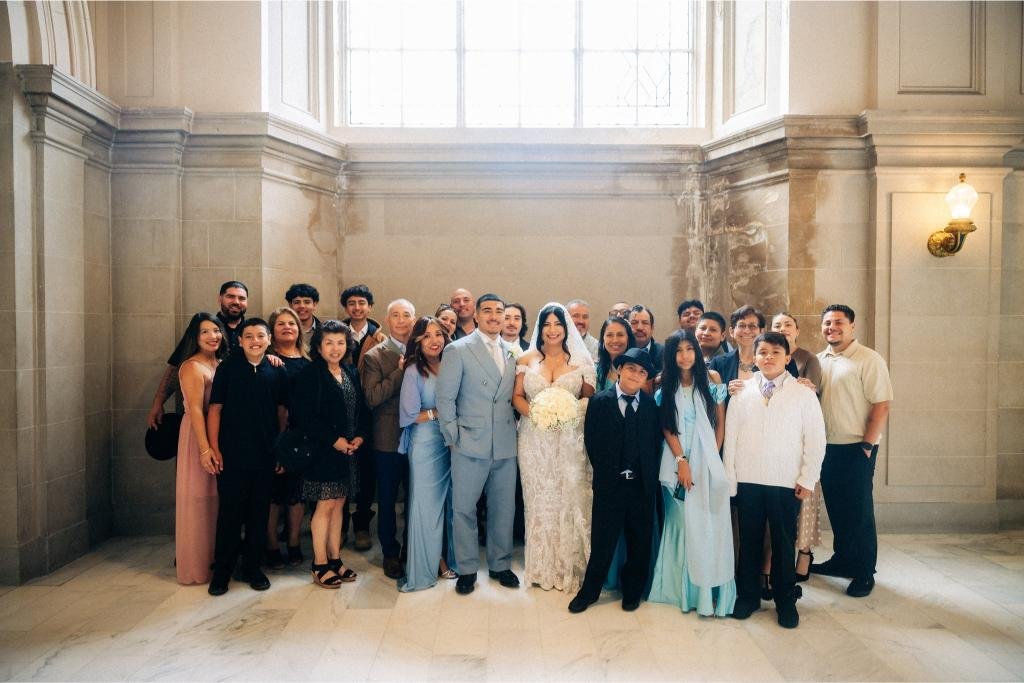 Bride and groom posing with their wedding guests after their San Francisco City Hall ceremony