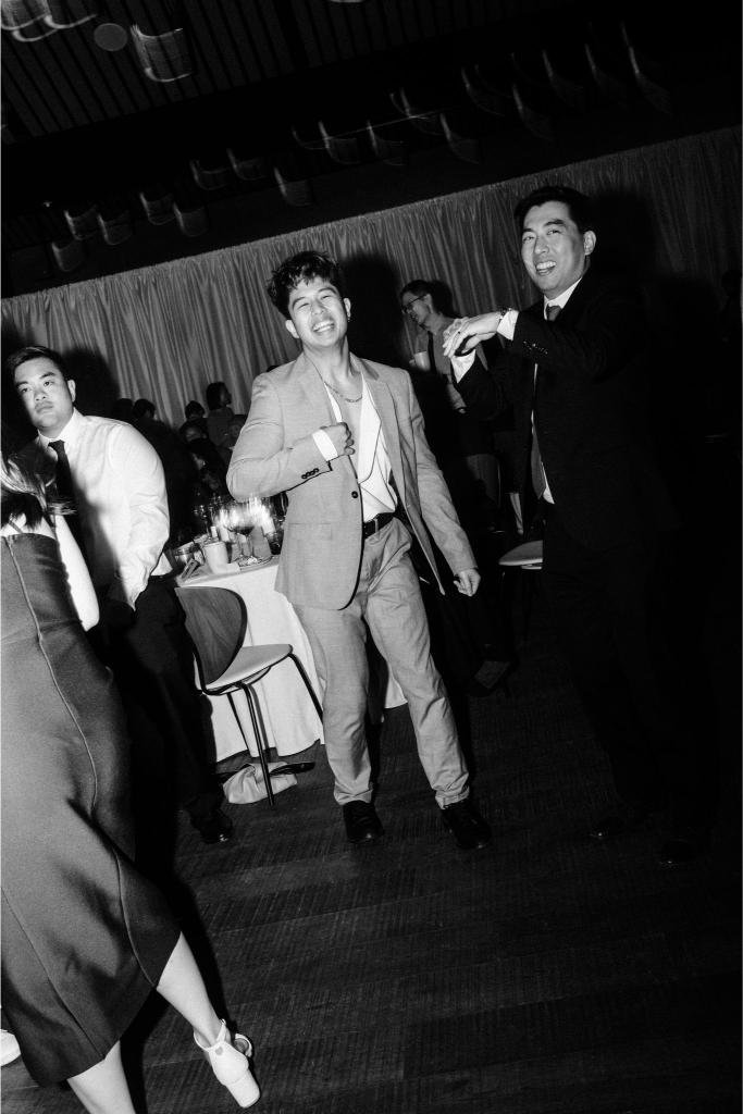 Wedding guests smiling together on the dance floor