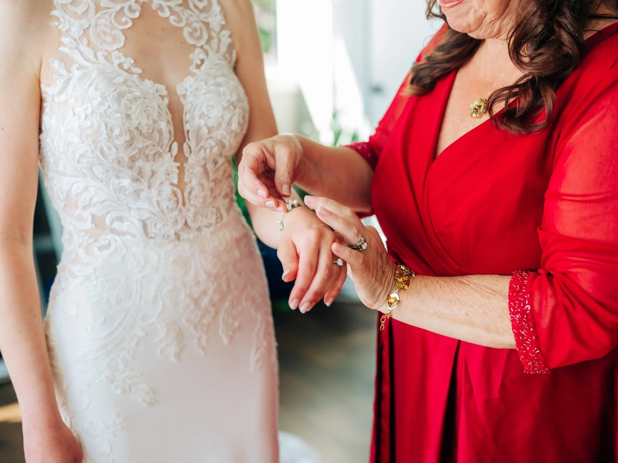 Bride’s mother helping her put on bracelets while getting ready for Maverick’s Beach House wedding in Half Moon Bay