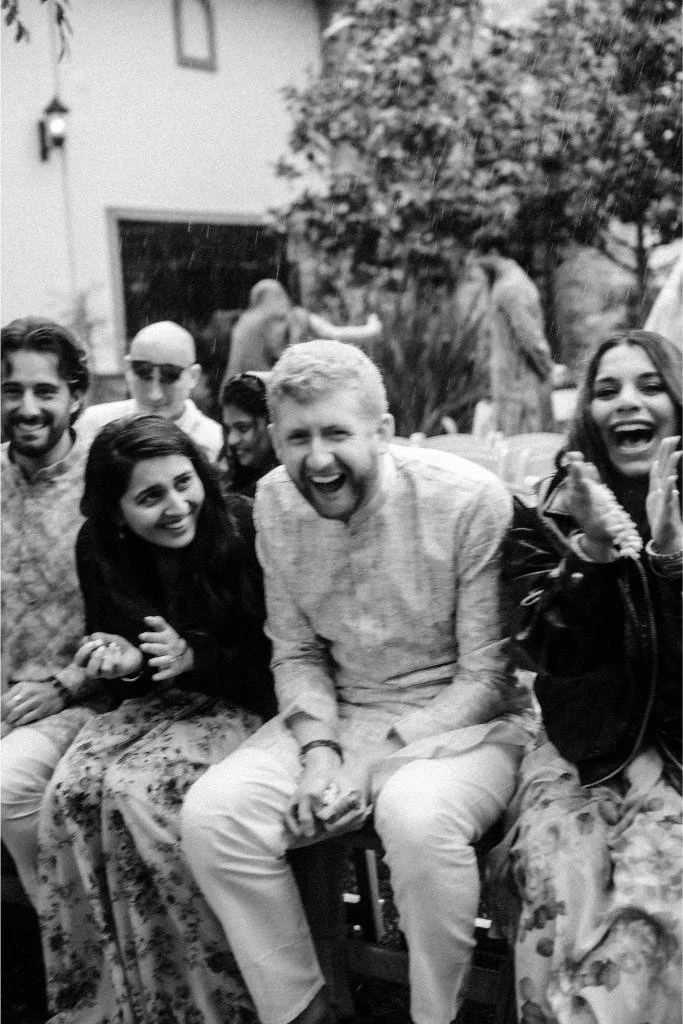 Smiling wedding guests watching Nishi and Rohan’s ceremony