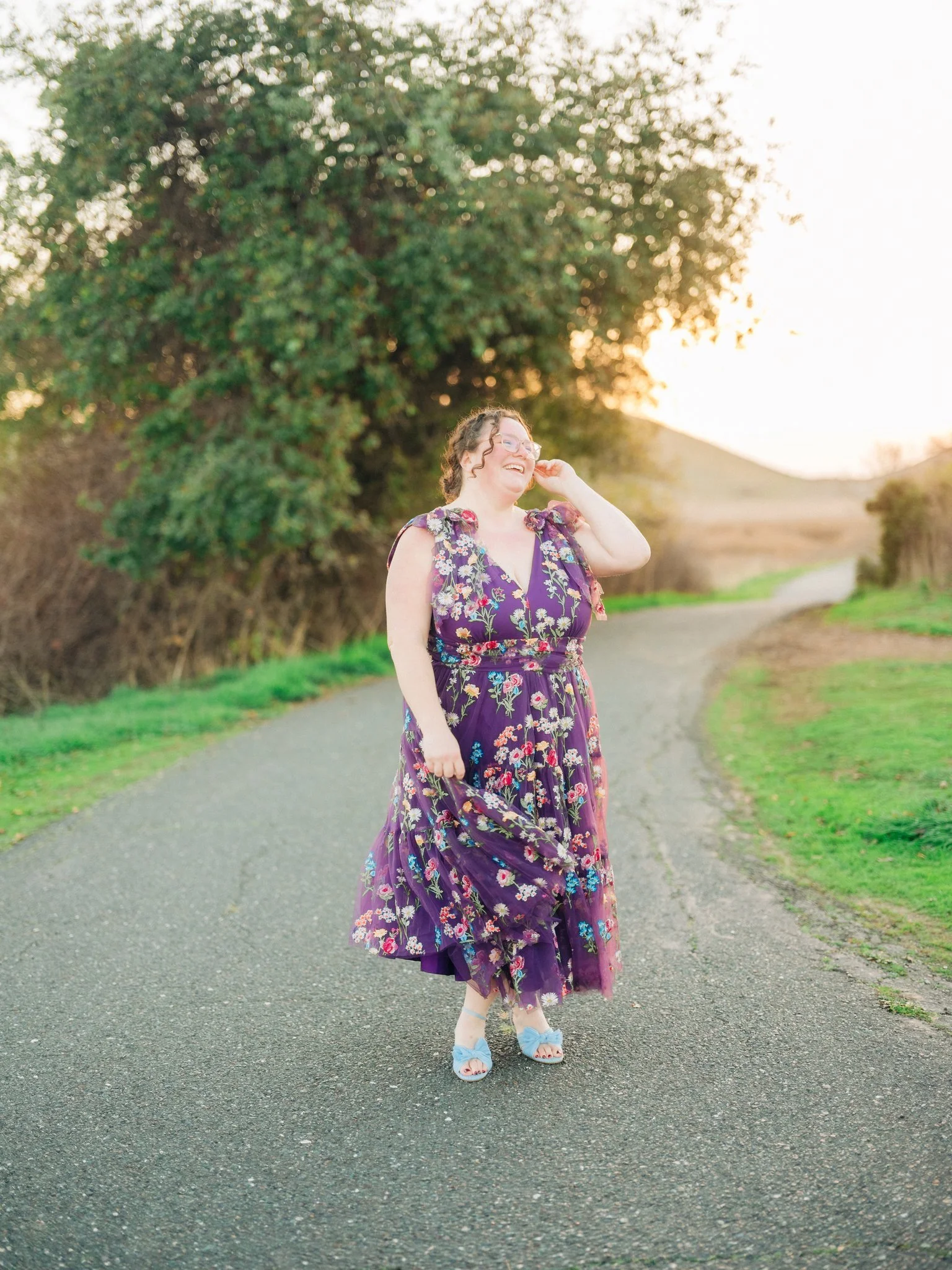 Woman in a dress posing on a path with mountains in the background at Coyote Hills Regional Park in Fremont CA