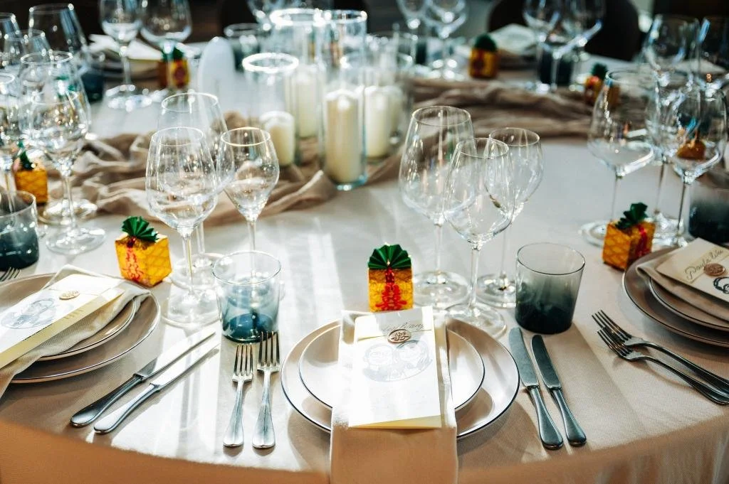 Wedding reception table set with plates and wine glasses before guests arrive