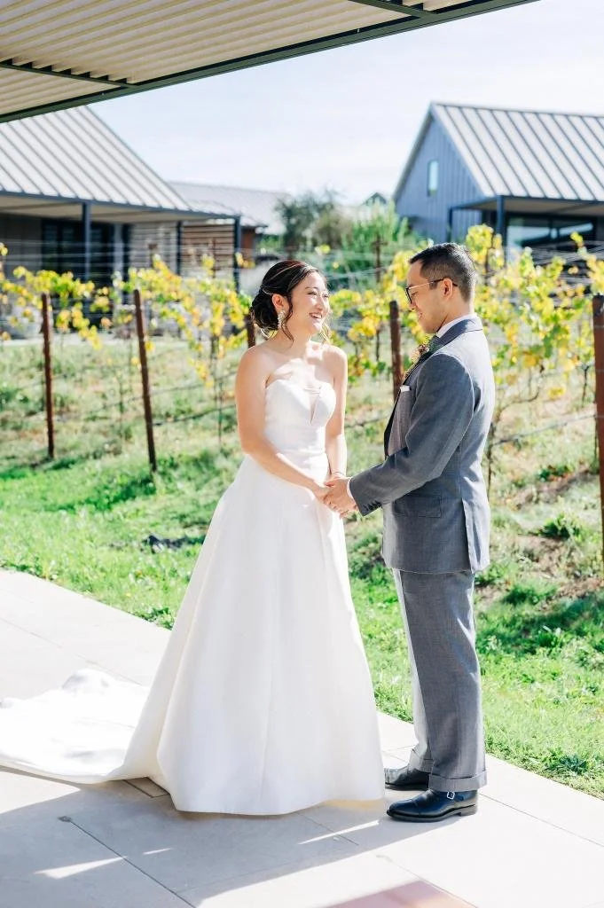 Bride and groom holding hands during their first look at Stanly Ranch