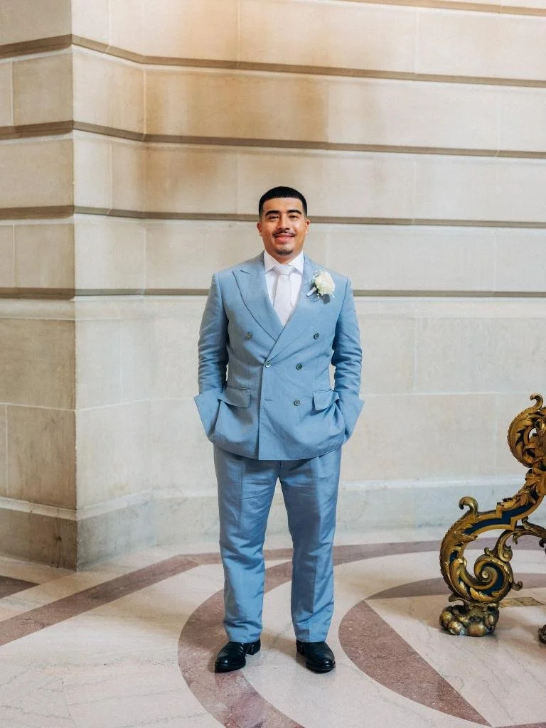Solo portrait of the groom in his blue suit.