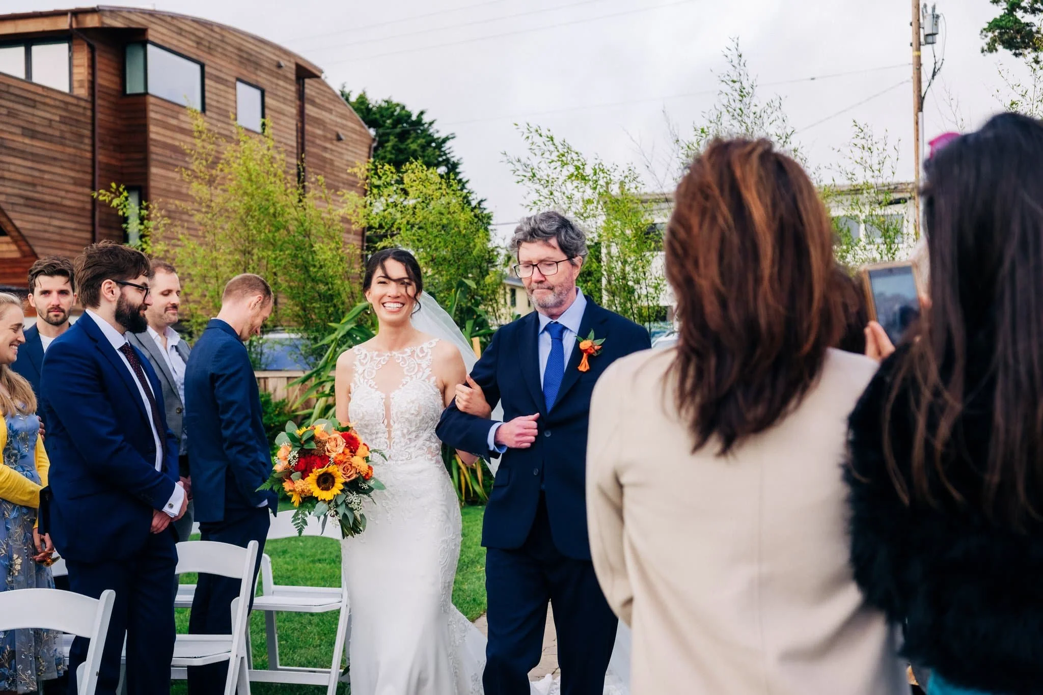 Father walking bride down the aisle during ceremony at Maverick’s Beach House wedding in Half Moon Bay