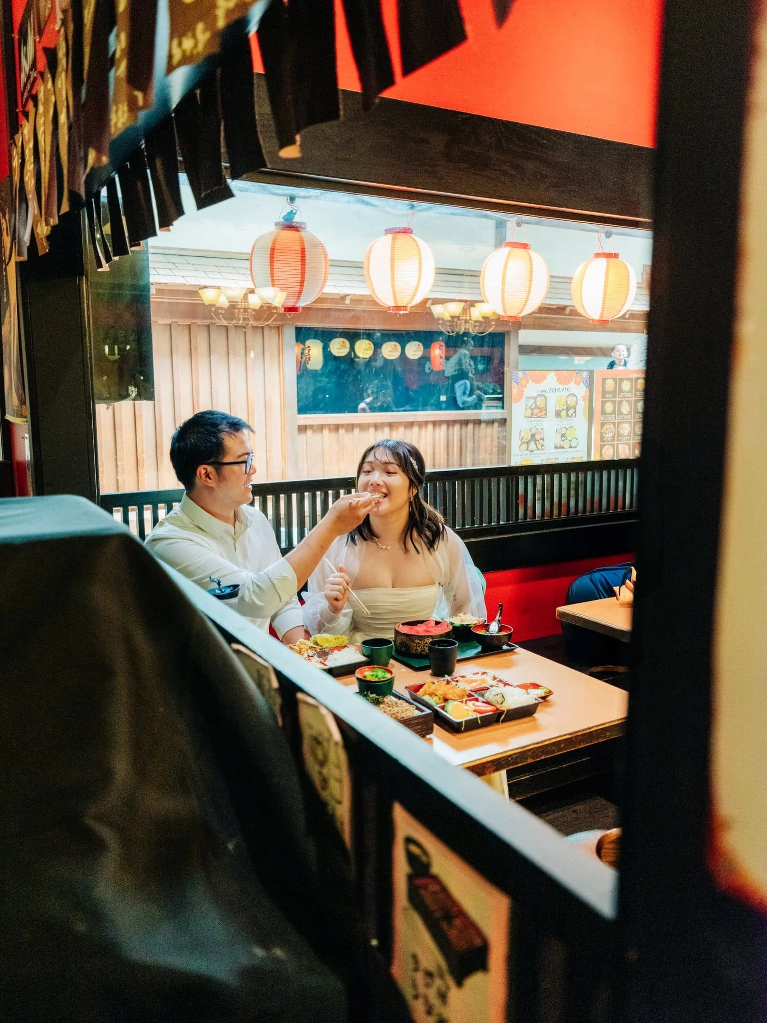 Groom feeding the bride during their San Francisco Japantown elopement celebration at Yakitori Edomasa.