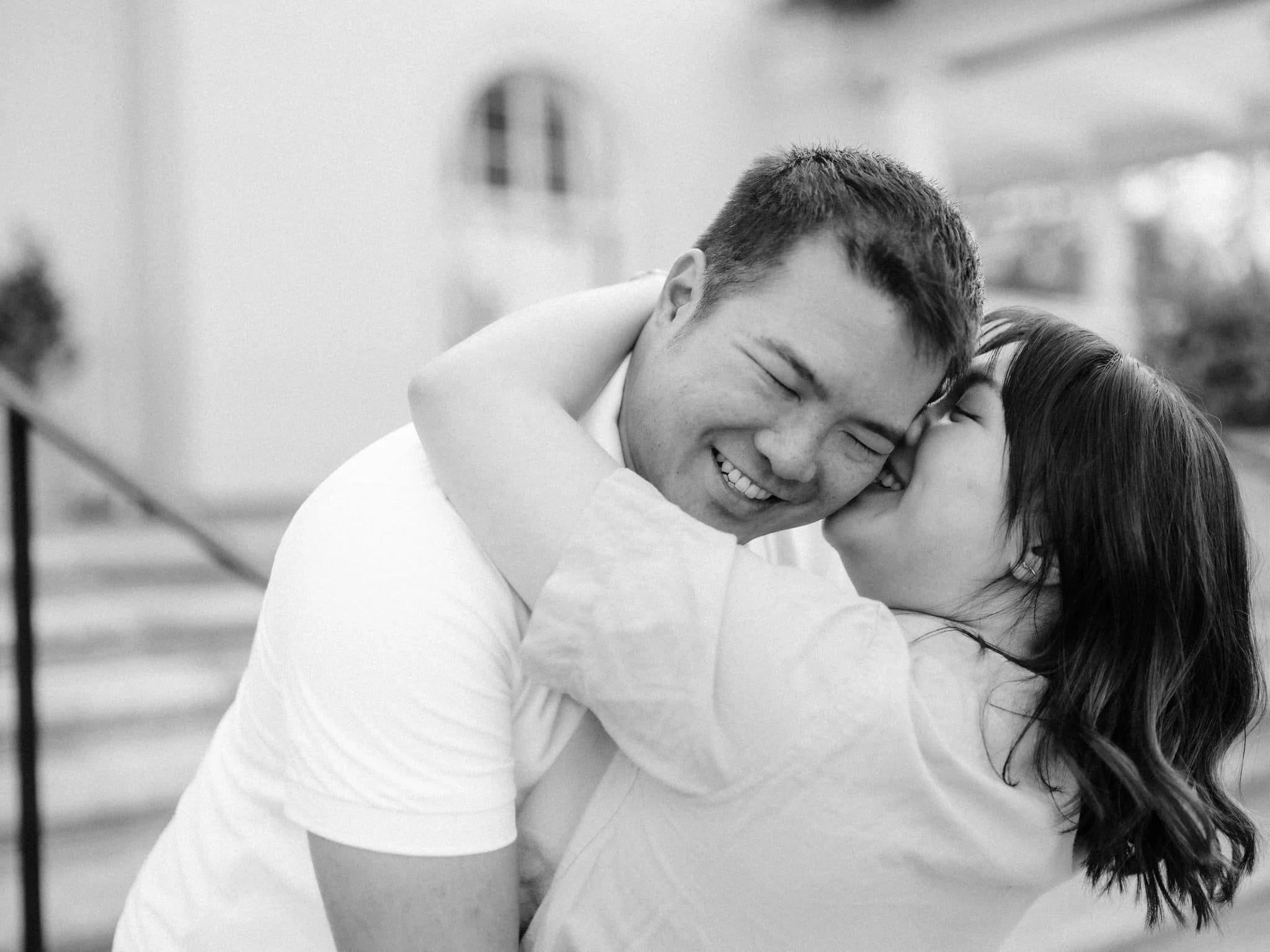 Couple embracing and smiling during their Montalvo Arts Center engagement photos in Saratoga.