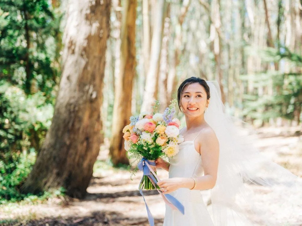 Bride posing with her bouquet during wedding portraits at Lover's Lane in the Presidio.