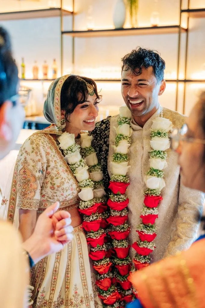 Bride and groom smiling side by side after exchanging their vows
