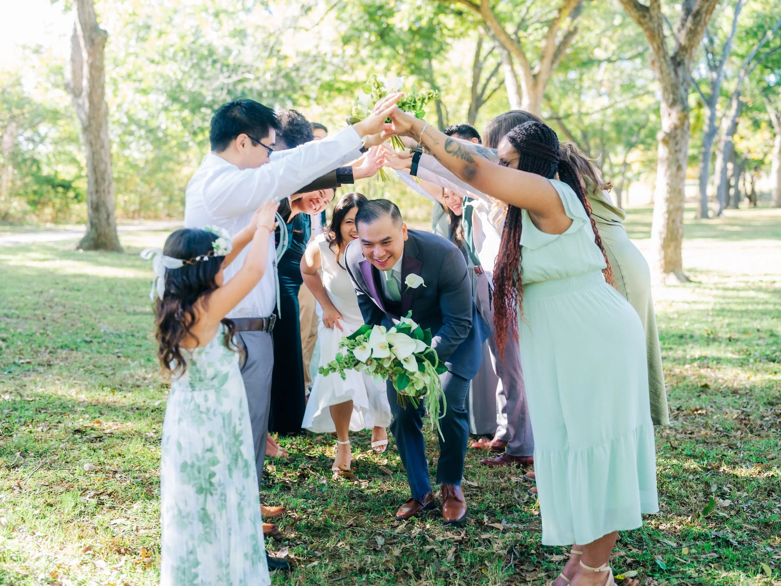 Bride and groom walking through tunnel of guests during wedding reception celebration