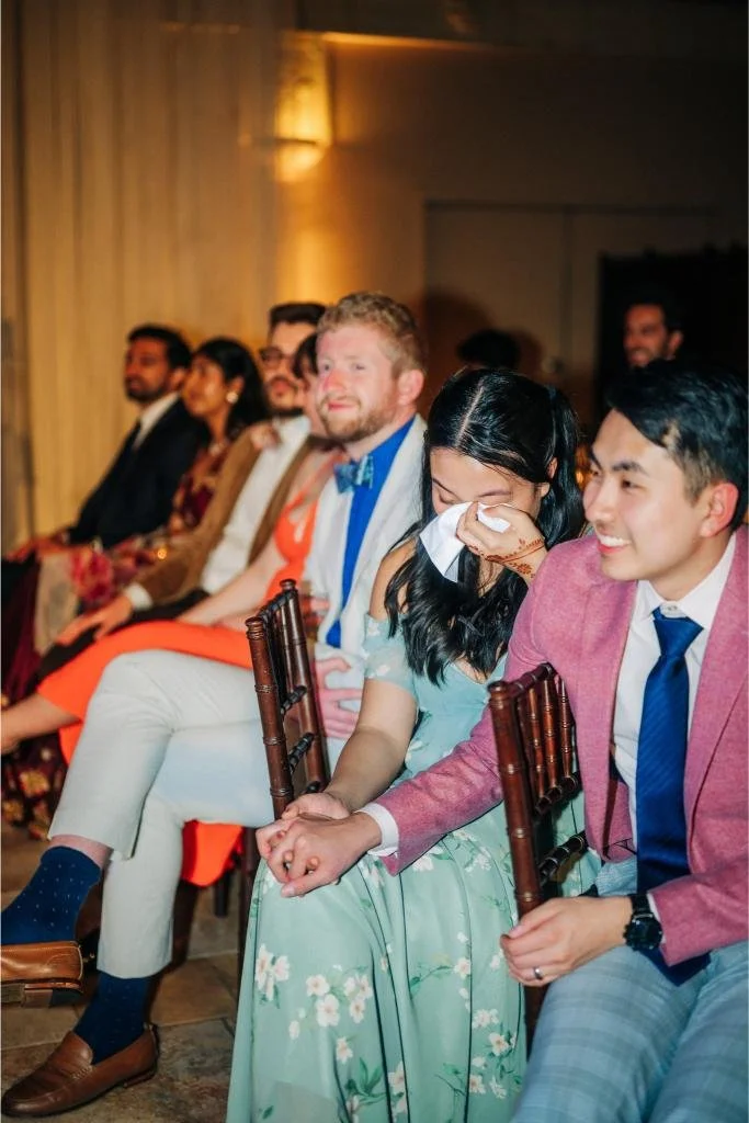 Wedding guest wiping away tears during an emotional reception speech