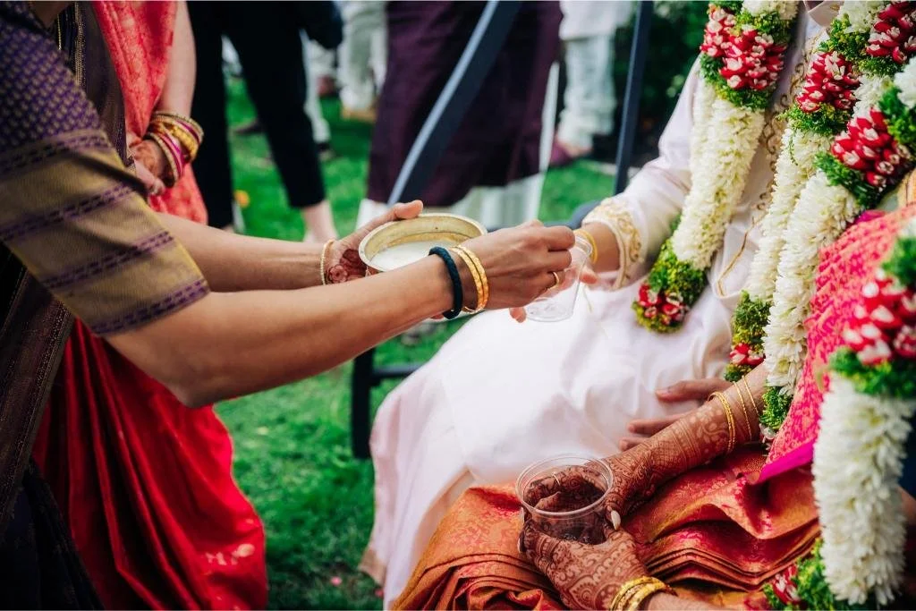 Bride and groom being served a drink during the wedding ceremony