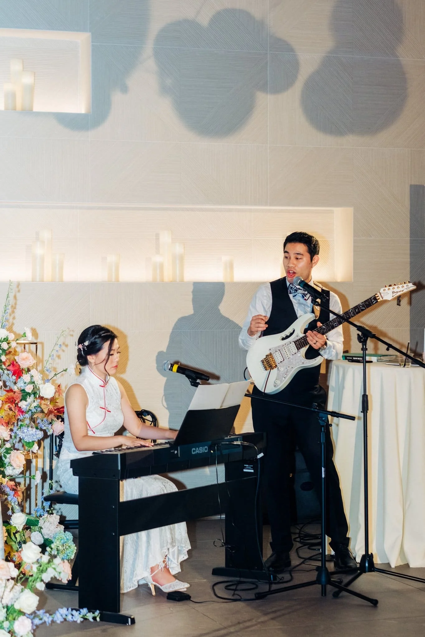 bride on piano and groom playing guitar live music performance wedding reception palm event center pleasanton