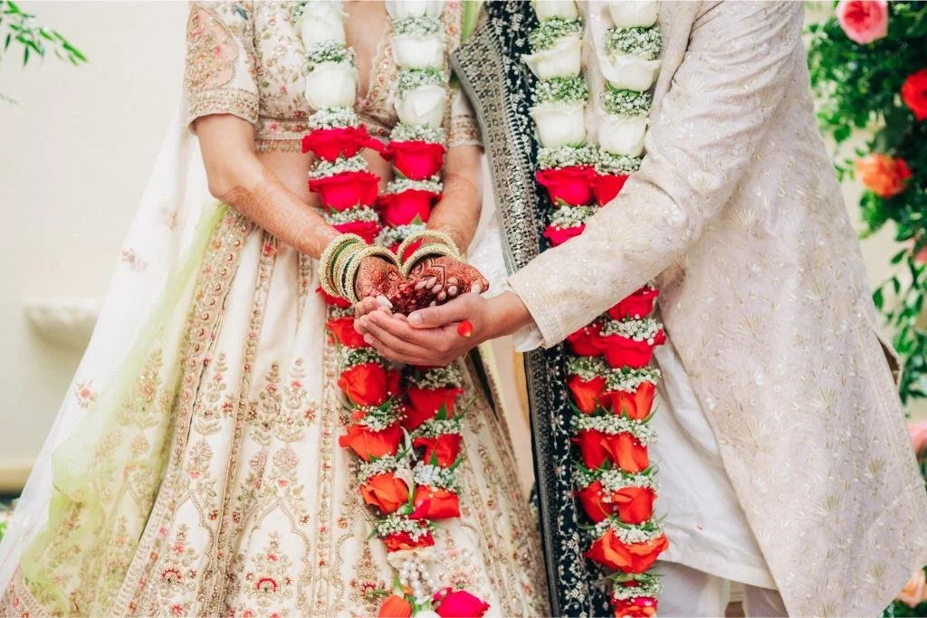Bride and groom holding hands at the altar during their wedding ceremony